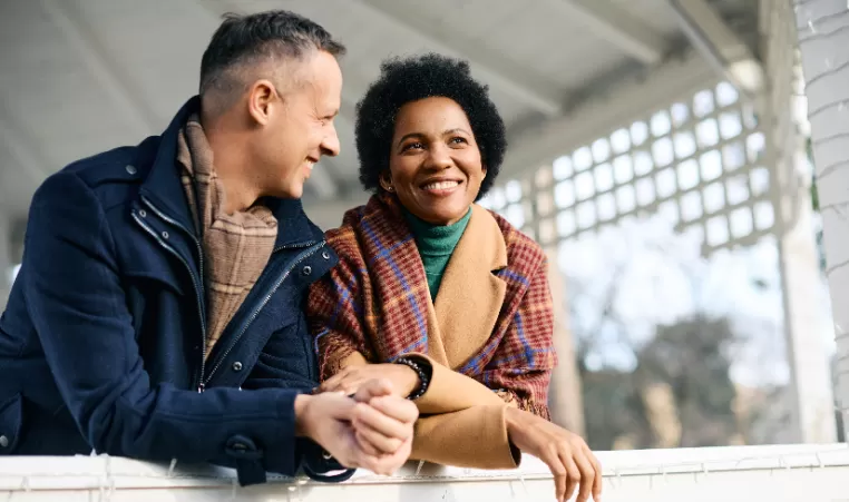 man and woman smiling outside in the winter