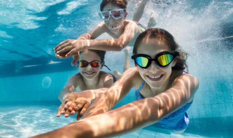 3 kids swimming under water