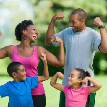 Family of four flexing their muscles
