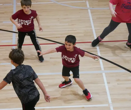 kids playing basketball in a gymnasium