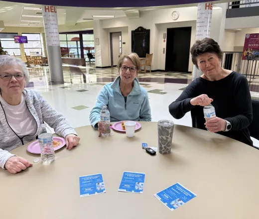 three women enjoying snacks in the YMCA lobby