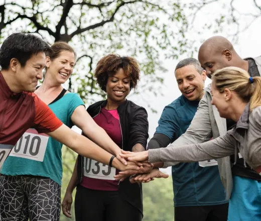 running group friends stacking hands